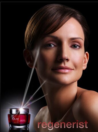 Woman showing olay regenerist erum